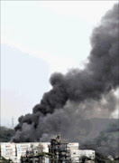 BLOTTING OUT LANDSCAPE: A massive oil tank near Amanzimtoti, south of Durban, exploded at the weekend injuring four workers. Pic: TEBOGO LETSIE. 25/10/2009. © Sunday Times.