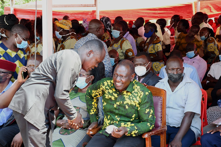 Deputy President William Ruto with Busia Kuppet executive secretary Moffats Okisai at Machakusi in Teso South on October 23, 2021.