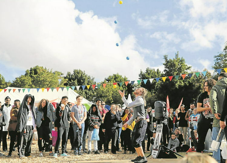 Sven, a Swedish street performer, does his act in front of an appreciative crowd at the 2019 National Arts Festival in Makhanda