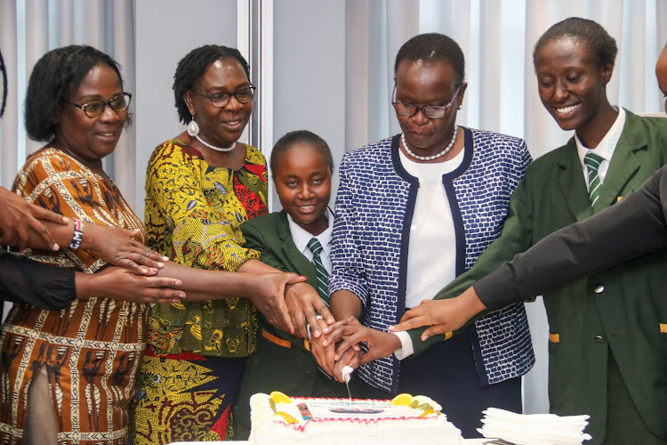 Chairperon FAWE Kenya Prof. Genevieve Mwanyuli, FAWE Africa Executive director Martha Muhwezi, student Rosemary Wambui, Director of policy and partnerships in the EA Community Evelyne Owuoko and Nyanjwa Sheila in a cake cutting session during the launch of the Imarisha Msichana programme at a hotel in Upper Hill on June 28, 2022.