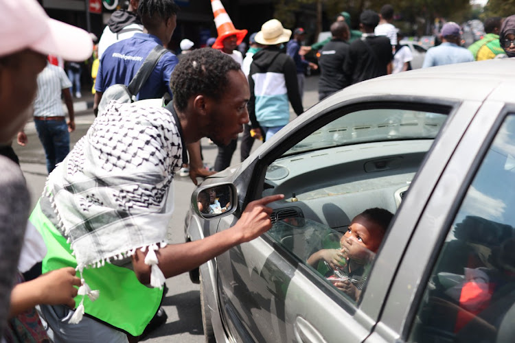 Protesting students stop traffic as they march through Braamfontein, Johannesburg, near the University of the Witwatersrand on March 2 2023.