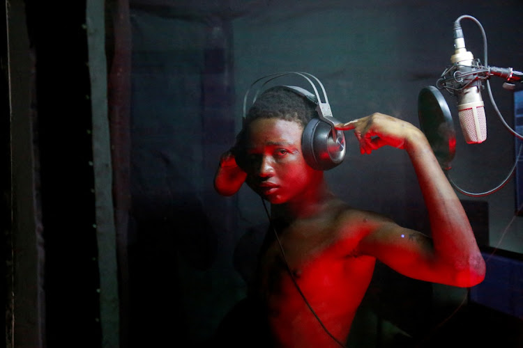 Oze Makvala, 19, a homeless teenager who has slept rough on the streets for years, sings at the studio of Mokili Na Poche cultural centre, a Congolese arts refuge that helps street children, in Kinshasa, Democratic Republic of Congo September 5, 2023.