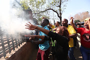  ANC supporters of former premier Senzo Mchunu burn impepho  outside the High Court in Pietermaritzburg.