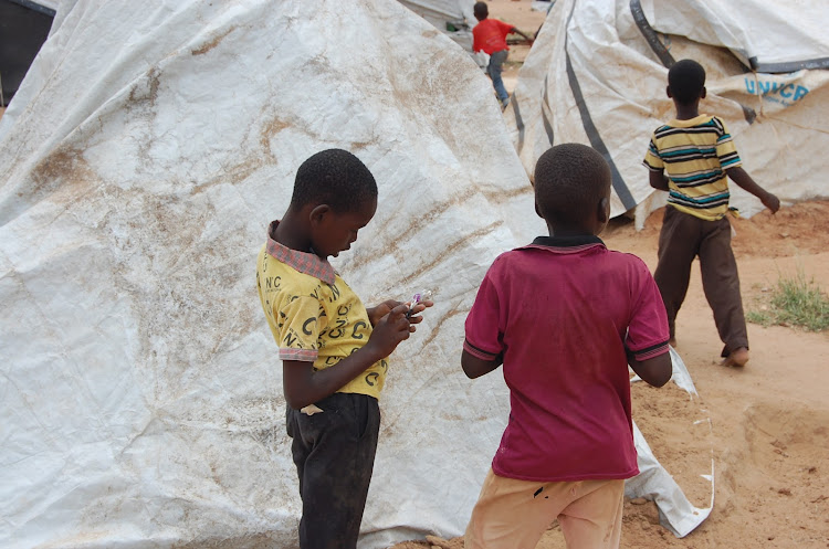 Children displaced from Bakuyu by floods at the Farmers Training Centre on May 13, 2020.