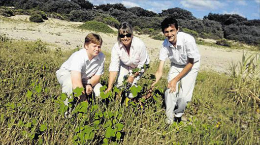 PRICKLY INVADER: Merrifield College teacher Pauline Wetmore and two of the school’s Enviro Club pupils, Justin and Gary Osner, with the invasive, thorny and poisonous large cocklebur weed, which, together with the tumbleweed, is taking over the the fore dunes alongside Nahoon river and beach