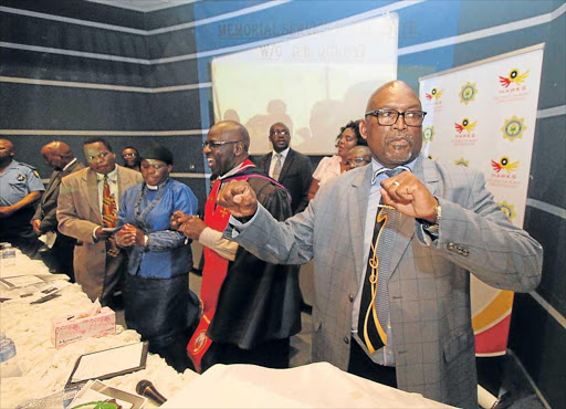 WAR DECLARED: East London Hawks unit commander Colonel Sonwabiso Mboniswa and other leaders sing and dance during the memorial service of slain Mthatha Hawks member Warrant Officer Dalibandla Qokoyi in Mthatha yesterday Picture: LULAMILE FENI