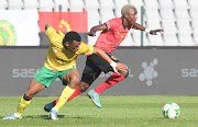 SA's Mothobi Mvala and Miguel Viera of Angola during the 2022 African Nations Championship qualifier at Dobsonville Stadium.