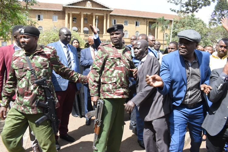 Police officers with Nairobi MCAs as they storm Supreme Court reclaims their parking lot on November 9, 2022