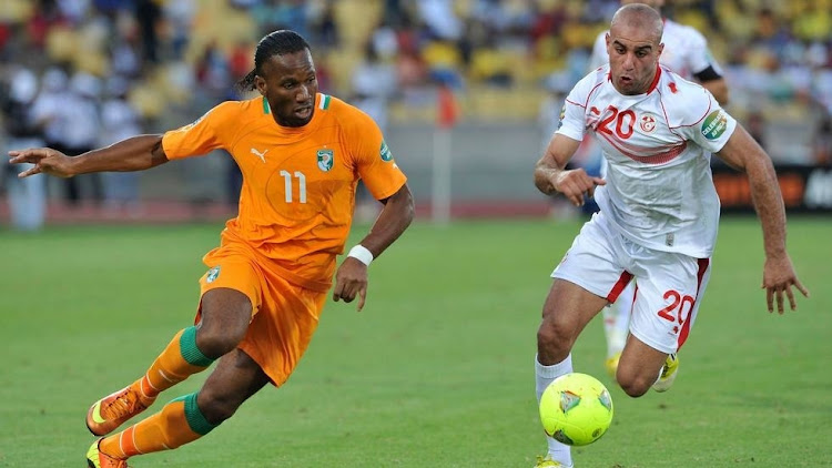 Ivory Coast's Drogba challenges Tunisia's Abdennour during a past Africa Cup of Nations match in Rustenburg