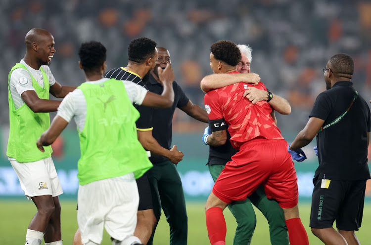 Bafana Bafana coach Hugo Broos embraces captain and quarterfinal hero Ronwen Williams, who stopped four kicks in the shootout, as South Africa celebrate their penalties victory in their African Cup of Nations win against Cape Verde At Stade Charles Konan in Yamoussoukro, Ivory Coast on Saturday night.