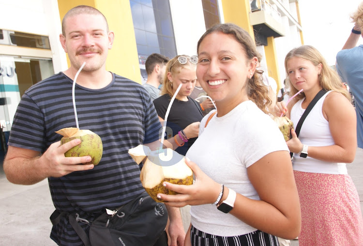 Tourists enjoying local drink 'Madafu'.