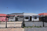 A house (on the left) belonging to Johanna Marokane in Mzimhlope, Orlando West is pictured adorned in Orlando Pirates colours and slogans on November 3 2021. The joined house on the right used to be painted in Kaizer Chiefs colours but the occupants have since repainted it white.
