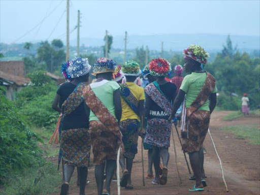 Girls walk to a shopping center in Kuria East on Tuesday evening after they were released from a recovery zone after FGM.Any girl who evades the cut is seen as an outcast on December 3,2015. Photos/ Alvin Ratemo.