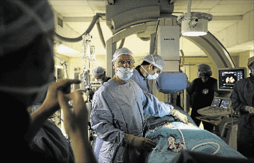 SAVING A LIFE: Doctors at the Panorama Medi Clinic in Cape Town perform a revolutionary heart valve operation Picture: GALLO IMAGES