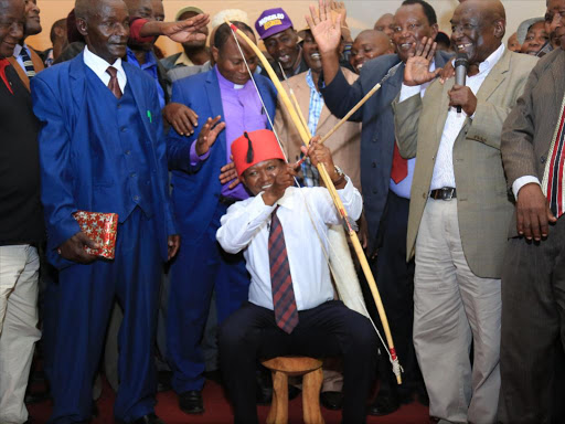 Maendeleo Chap Chap party leader Dr Alfred Mutua is gifted a bow and guiver of arrows by Kamba elders during a leaders meeting at the Machakos People's Park./COURTESY