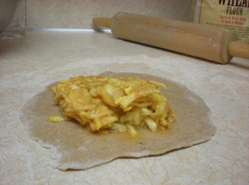 The filling on top of the dough before being folded over to create the pocket.