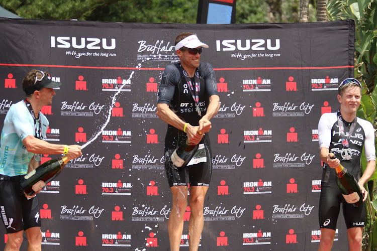 IRONMAN 70.3 winner Matt Trautman flanked by Bradley Weiss (second) and Henri Schoeman (third) in East London on Sunday