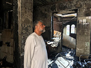 Yusuf Kajee, CEO of Amalgamated Tobacco Manufacturing Africa,  inside one of the flats gutted by a fire in Durban on Monday. 