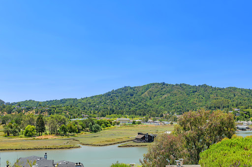 Green hills and calm water body in this luxury property for sale in Greenbrae ($795,000)