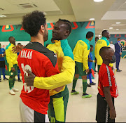 Senegal star Sadio Mane embraces his Liverpool teammate Mohamed Salah before the match.