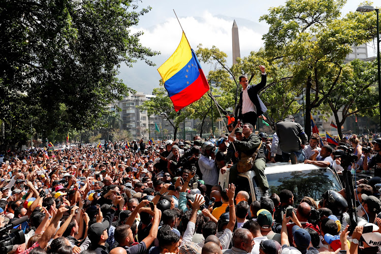 Venezuelan opposition leader Juan Guaido, who many nations have recognised as the country's rightful interim ruler, gestures after talking to supporters in Caracas, Venezuela, on April 30 2019.