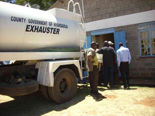 1-3.Nyandarua County workers empty raw sewage into the offices of Nyandarua public service board yesterday