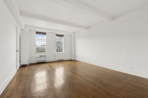 Bright living room hardwood floors white trim in this luxury apartment / penthouse for sale in New York ($615,000)