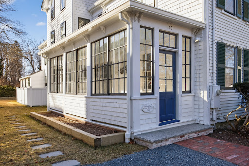 White glazed porch with blue door in this luxury house for rent in Sandwich ($17,000)
