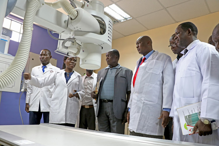 Governor Sospeter Ojaamong (2nd right) when he unveiled new equipment at Kocholia Level 4 Hospital in Teso North