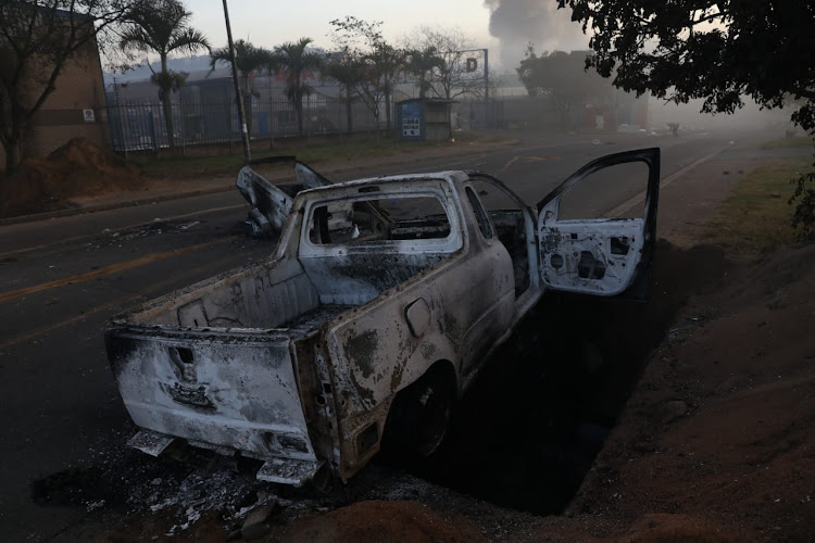 A torched vehicle abandoned on a road in Durban on July 12 2021.