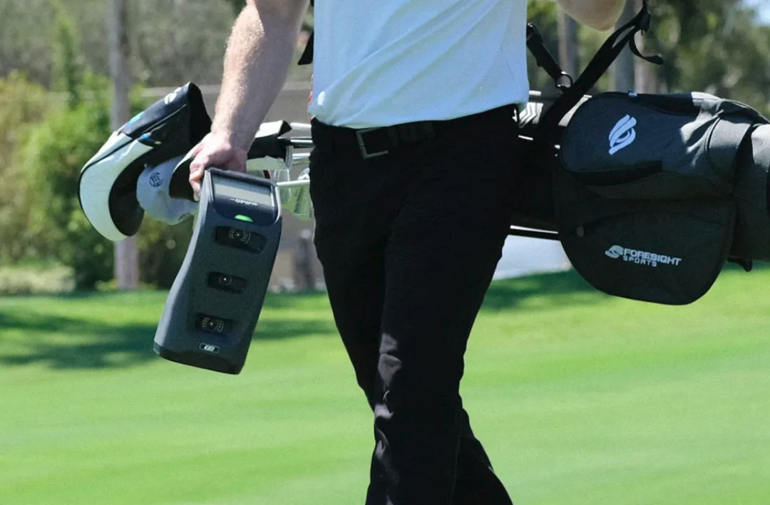 A person carrying golf clubs

Description automatically generated with medium confidence