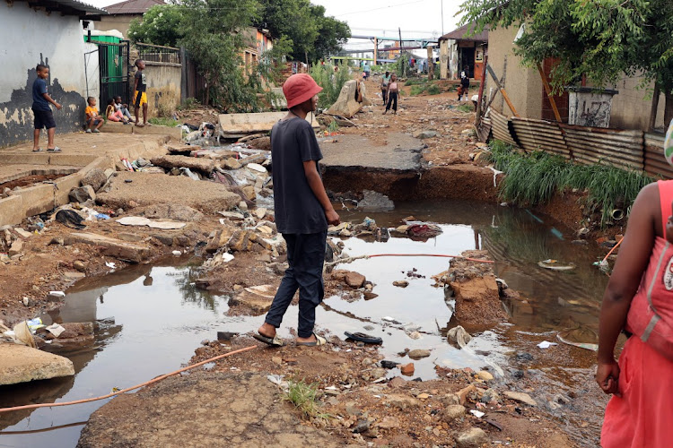 A road in Kliptown was completely destroyed by floods after a heavy downpour in Soweto on Saturday.