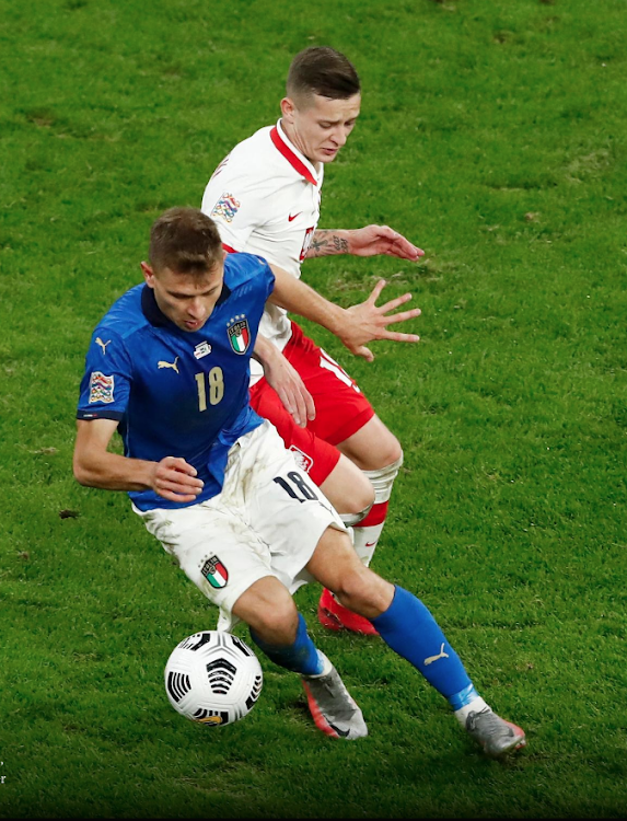 Italy’s Nicolo Barella vies for the ball with Poland’s Sebastian Szymanzki