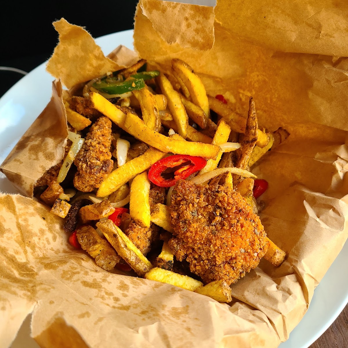 Spice bag: seasoned fried chicken bites, peppers, jalapeños, sautéed onions and fries