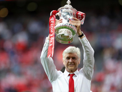 Arsenal manager Arsene Wenger celebrates with the trophy after winning the FA Cup final/Reuters