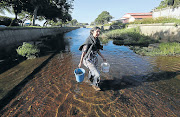 Volunteer Gill Lanham at work in Cape Town’s Liesbeek River. 