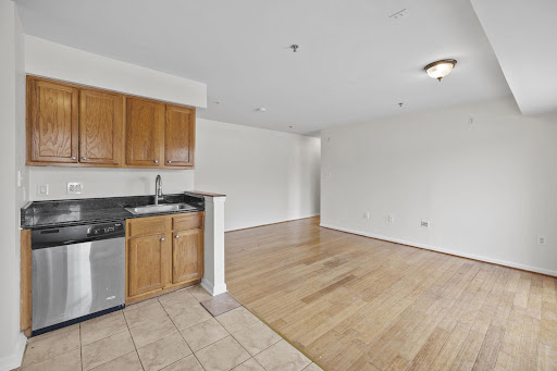 Kitchen with wood cabinets and empty living room - Luxury property for sale in Washington, 2 bedrooms