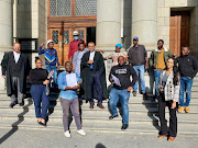 Empolweni residents, legal representatives, and community activists from Khayelitsha CAN outside the Western Cape High Court, which ruled that residents whose shacks were demolished can return to the land.