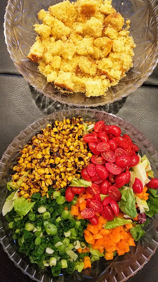 Recipe for cornbread salad - my version is an actual salad with romaine lettuce, and I omitted the beans but you can add the if you'd like just need a bigger bowl to put your salad in! I also served the bacon crumbles on the side so it could be vegetarian by default