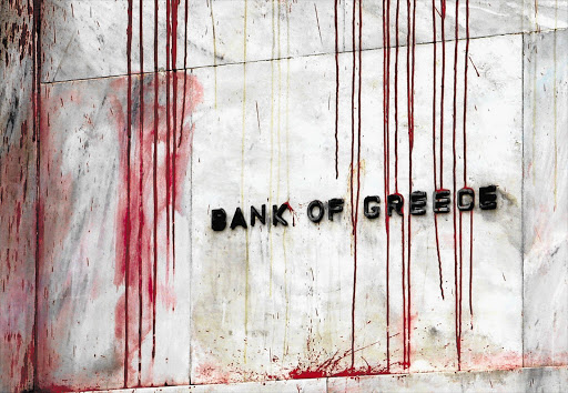 The Central Bank of Greece building in Athens, splattered with red paint thrown by demonstrators. Unemployment has risen above 25% and Coca-Cola Hellenic is moving its corporate operations and listing out of the country Picture: YANNIS BEHRAKIS/REUTERS