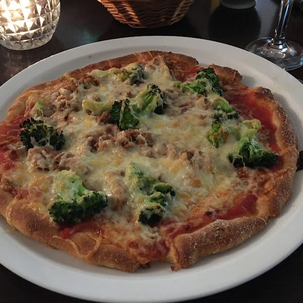 Pizza with cheese, tomato sauce, broccoli and tuna