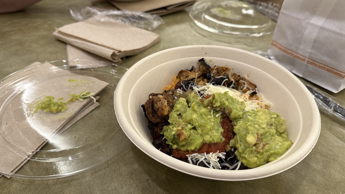 My bowl - red rice, beans, chicken, two salsas, cheese, and guacamole. And chips!