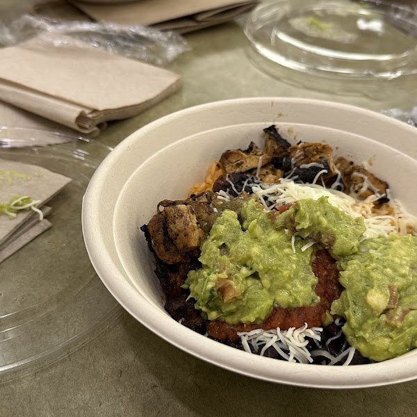 My bowl - red rice, beans, chicken, two salsas, cheese, and guacamole. And chips!