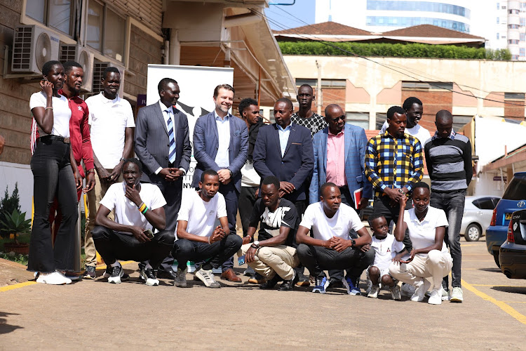 The the eight athletes who’ll benefit from the Refugee Olympic Program pose for a photo with NOC-K president Paul Tergat, Secretary General Francis Mutuku and Barnaba Korir
