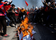Protesters cremate a dummy corpse representing a US infrastructure grant before cremating it during a protest against the $500 million US infrastructure grant under the Millennium Challenge Corporation (MCC) near the parliament in Kathmandu, Nepal February 18, 2022.  