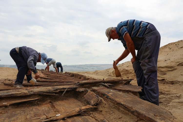 Archaeologists excavate the hull of a wooden ship, an ancient Roman flat-hulled riverine vessel at the ancient city of Viminacium, near Kostolac, Serbia, August 2, 2023.