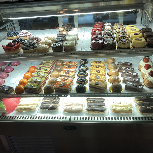 The domes are gluten free mousses (flavors: raspberry, mango, espresso, chocolate). The opera cakes are gluten free. The red velvet mousse cake (5th from the left on the top row) is gluten free.