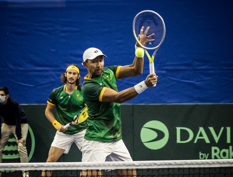 Raven Klaasen plays a volley as partner Lloyd Harris looks on in SA's doubles match against Israel's Daniel Cukierman and Jonathan Erlich in the Davis Cup World Group I promotion playoff in Ashdod, Israel.