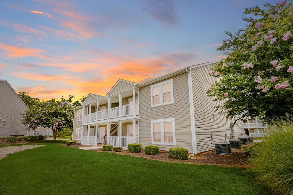 Winter Ridge & Montclair apartment building with light brown siding at dusk