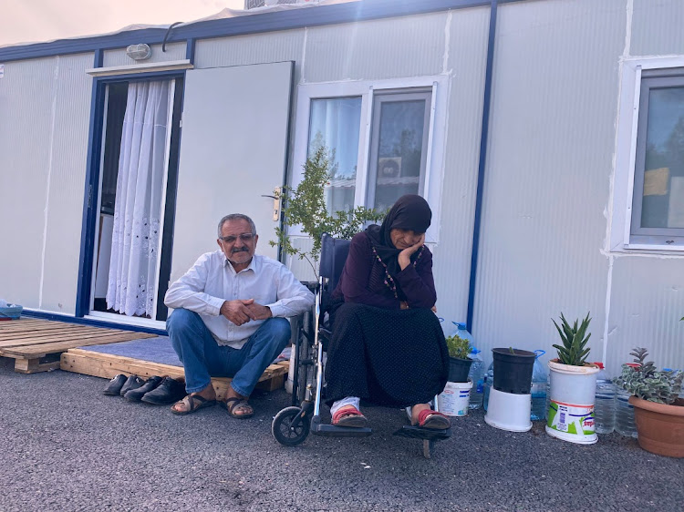 Earthquake survivors Ismet Kaplan and his disabled wife Meryem Kaplan are pictured in front of their container home in Adiyaman, Turkey on October 5 2023. Picture: REUTERS/Stringer